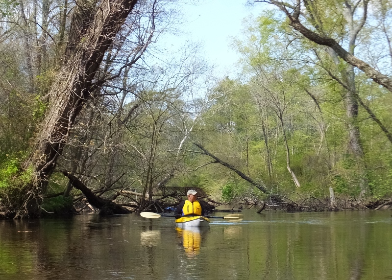 Mike in kayak with bridge in background