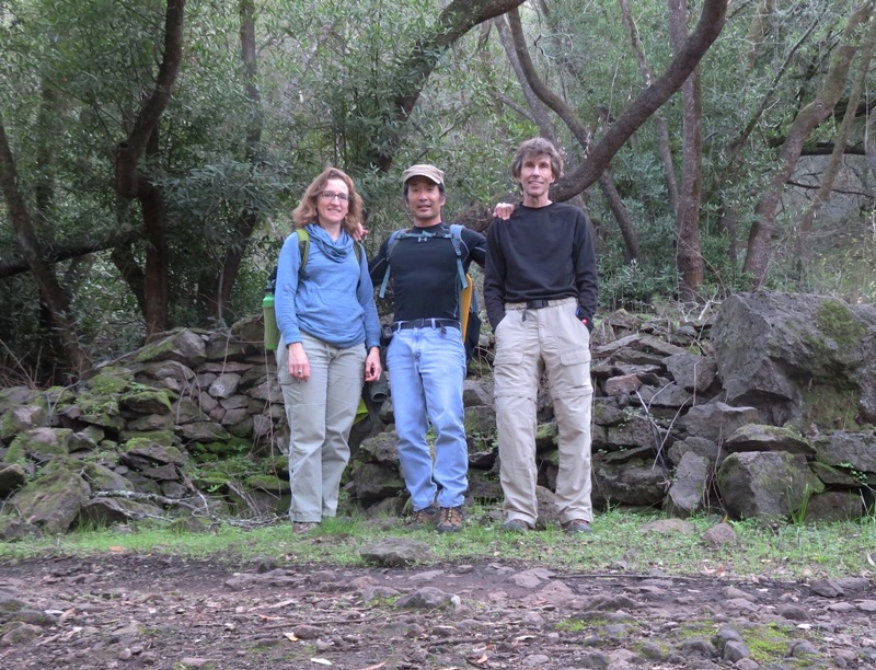Norma, Ken, and I in front of stone wall