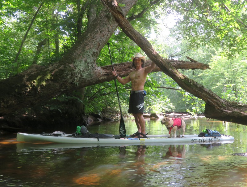 Me holding onto fallen tree with Daphne and me on SUP