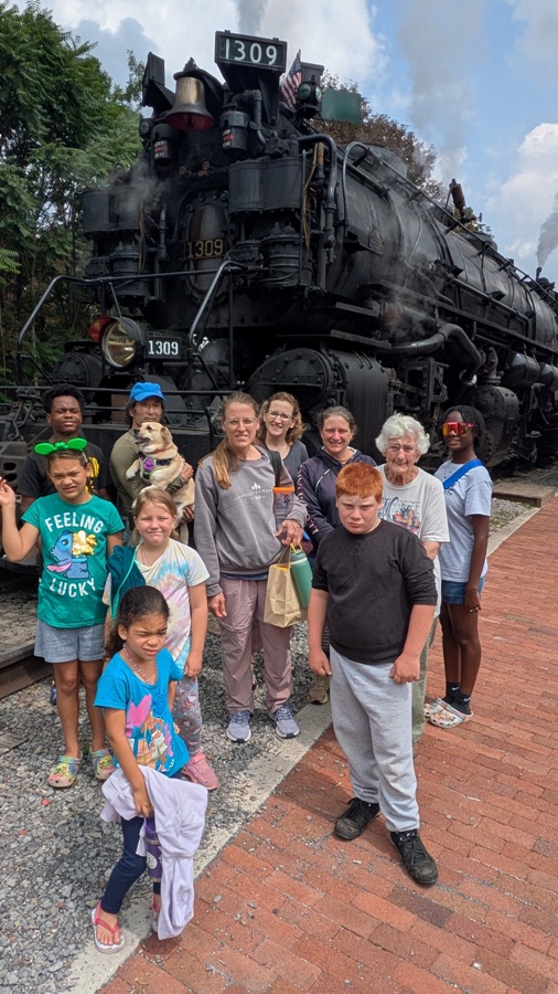 Group photo in front of train