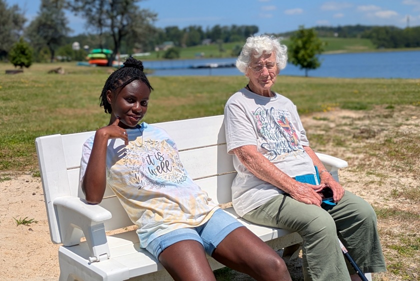 Oldest girl with Hazel sitting on bench at beach