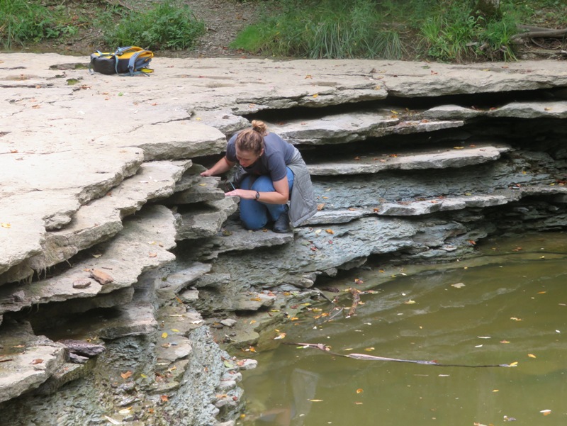 Norma looking for fossils at dry waterfall