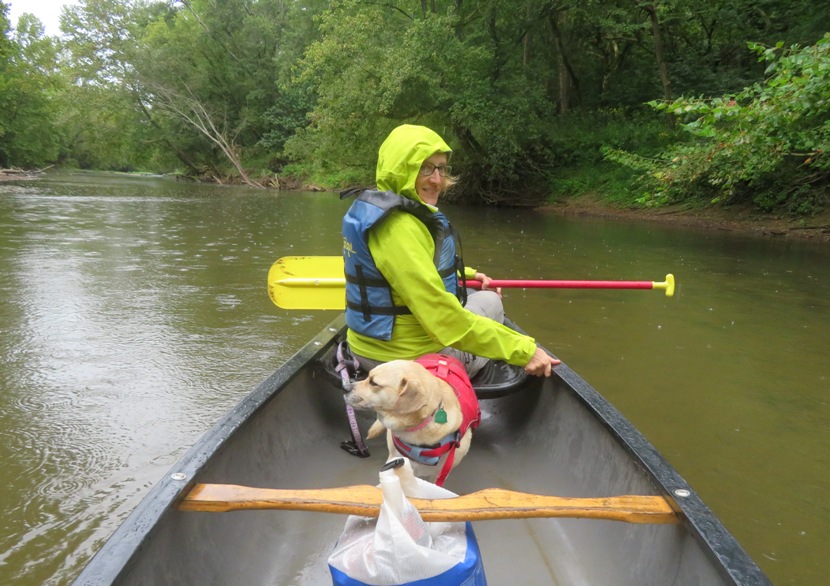 Norma and Daphne in canoe with raindrops hitting the water