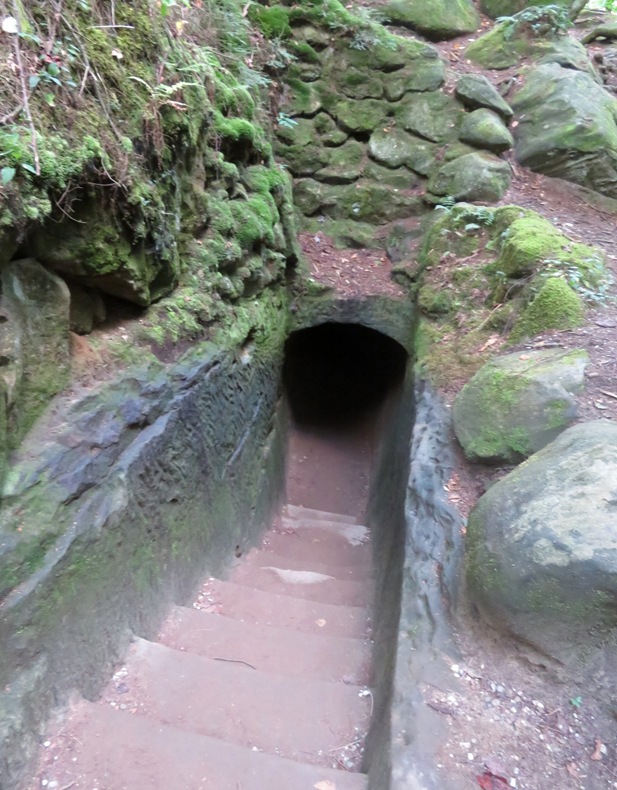 Stone stairs leading to tunnel in cliff