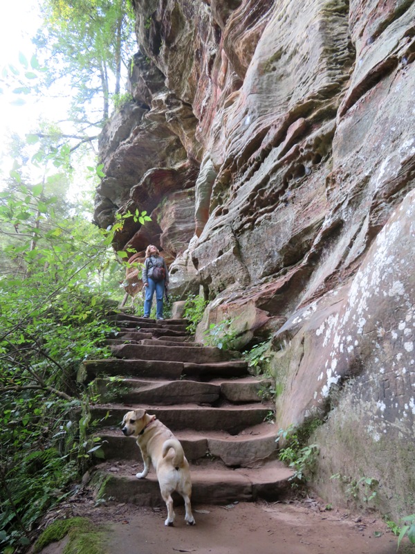 Norma and Daphne on stone stairs next to a vertical rock formation
