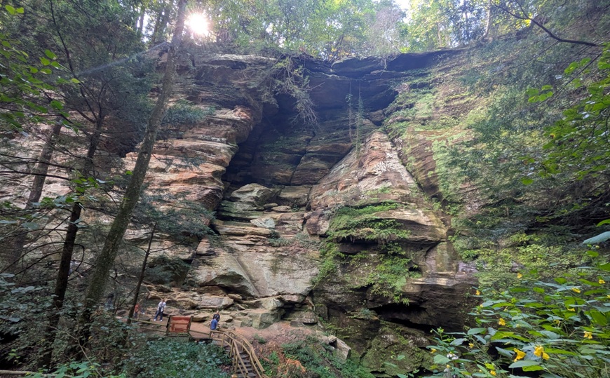 Really big rock wall with people at the base