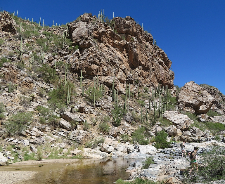 Water, tall rocks, and people