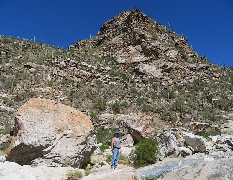 Me with tall, rocky view behind