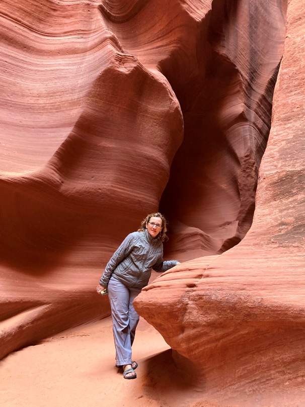 Norma leaning on a section of the canyon wall sticking out