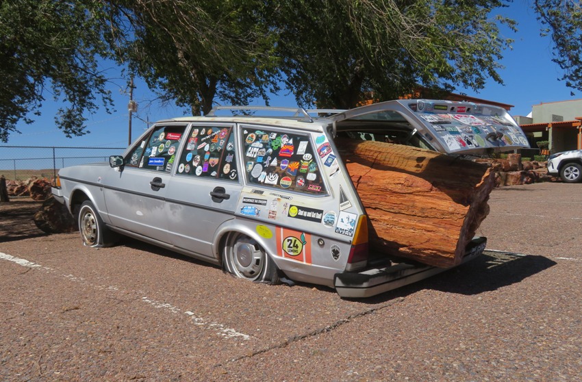 Station wagon with petrified log sticking out the back