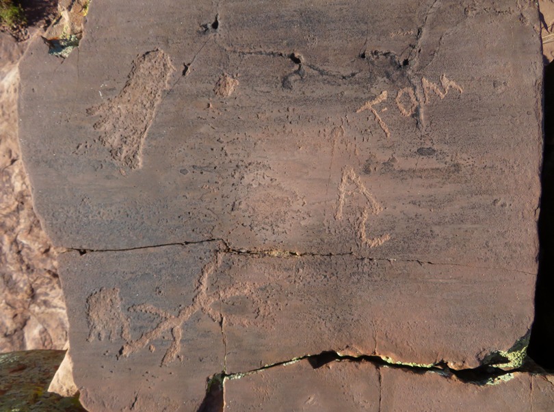 Stone with a mix of old and new carvings
