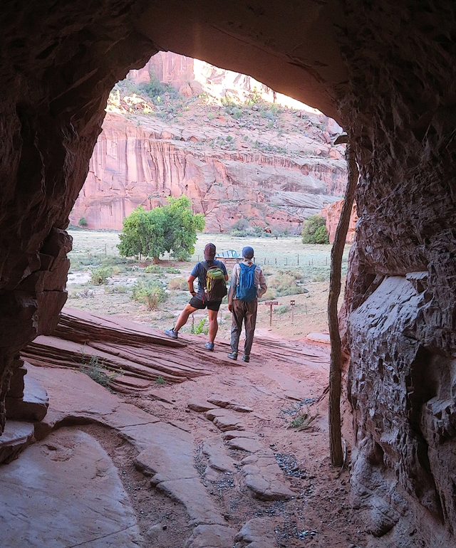 Looking at the backs of Robin and Carmen through opening in rock