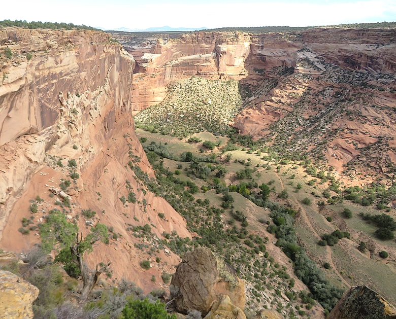 Steep canyon walls with a road at the bottom