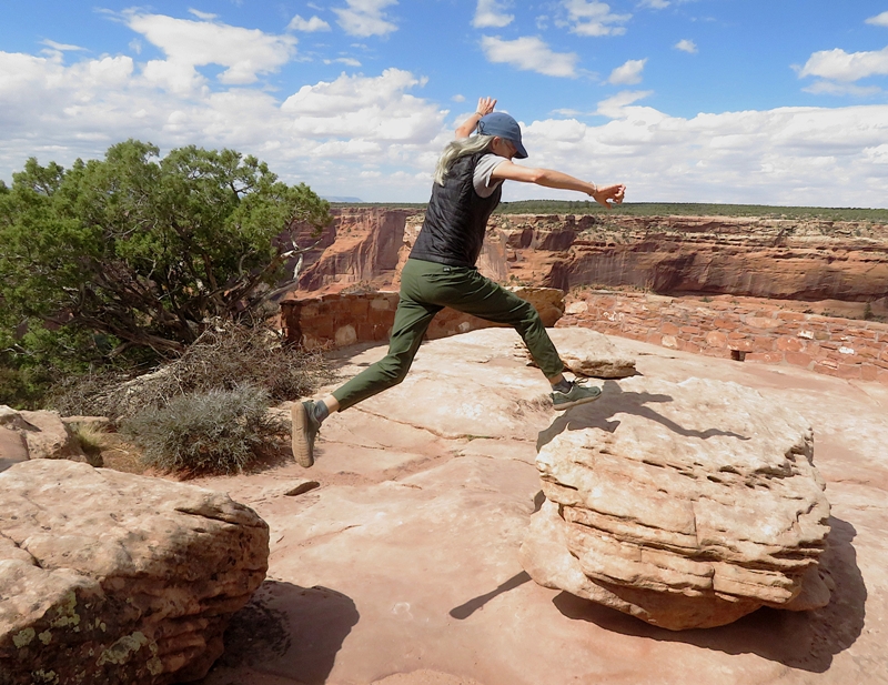 Carmen mid-air jumping between rocks