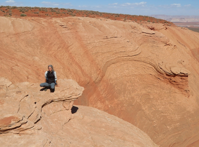 Carmen sitting near rocky ledge