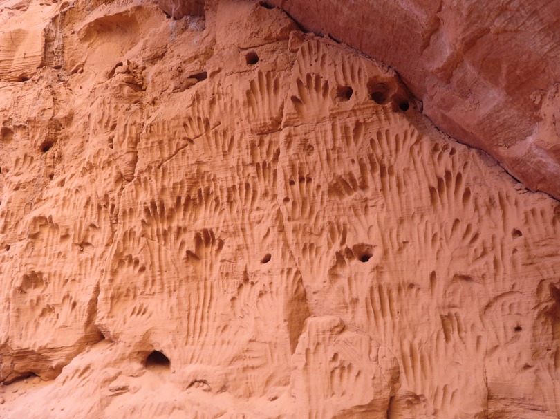 Hand and finger marks in a soft sandstone wall