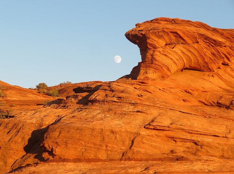 Rising moon framed by rock
