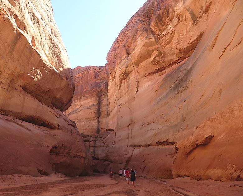People walking through the shaded canyon