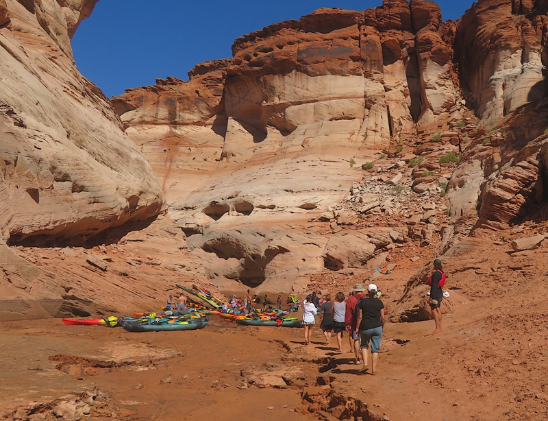 People walking back to their kayaks