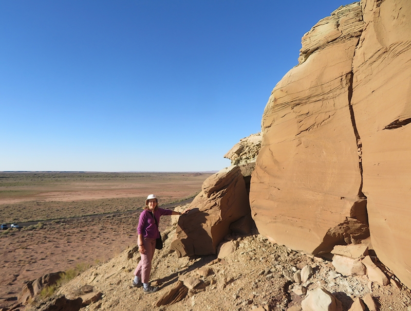 Norma leaning on a big stone