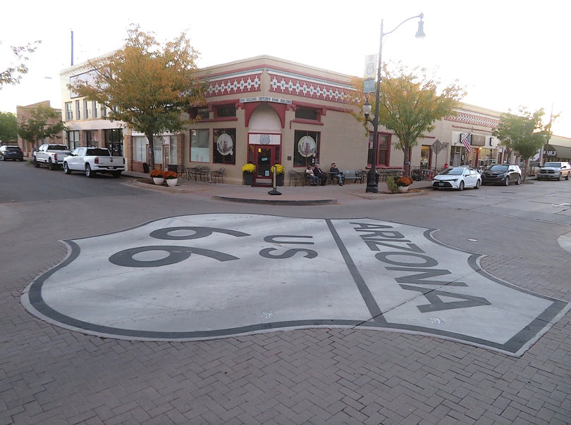 Route 66 sign painted on the ground at an intersection in Winslow