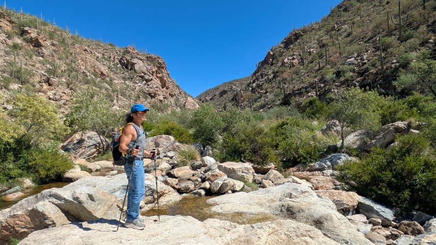 Me standing with hiking poles and running shoes