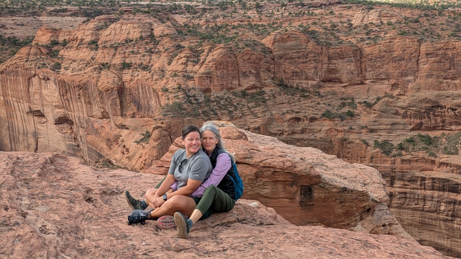 Robin and Carmen embracing at top of canyon
