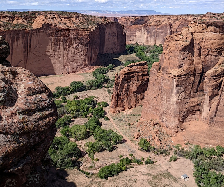 Well-lit canyon floor with building