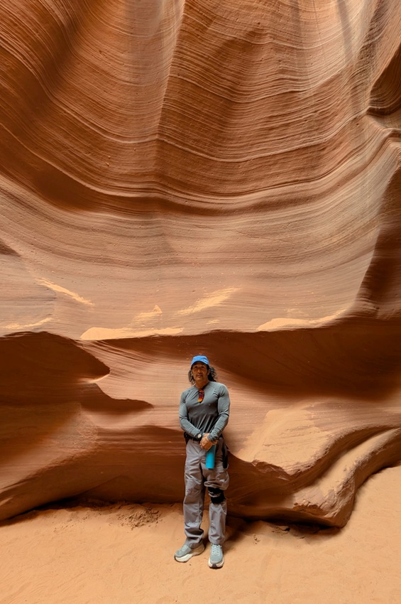 Me standing with a mix of orange and red rocks behind