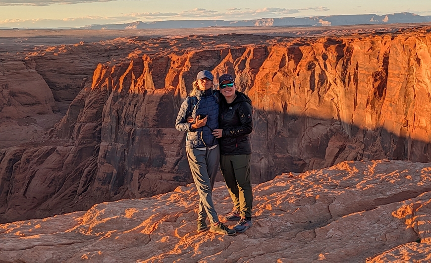 Carmen and Robin with a sunny/shady cliff wall in the distance