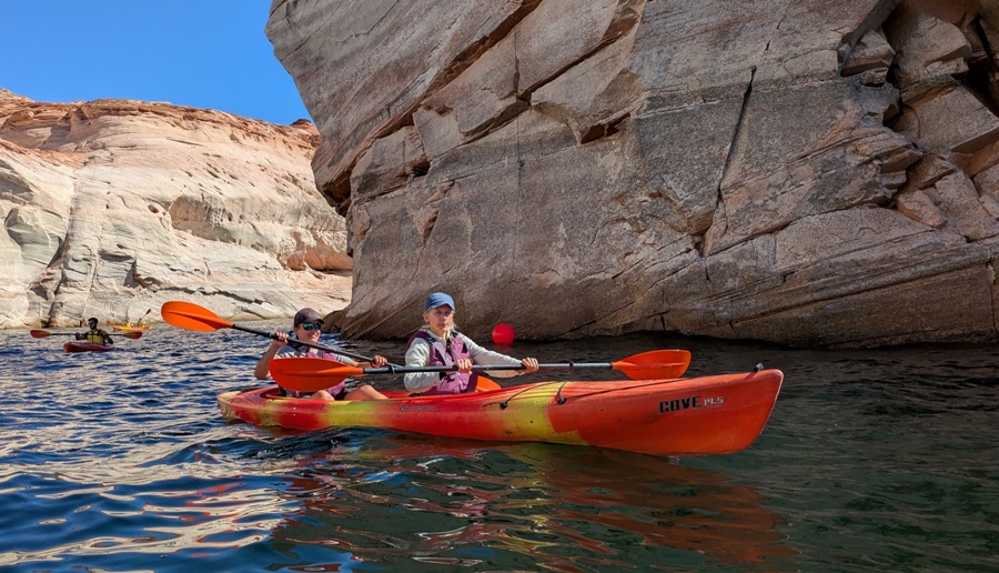 Robin and Carmen kayaking past an orange marker