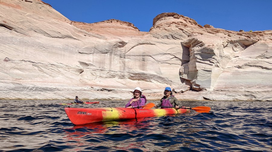 Norma and I paddling with white canyon wall behind