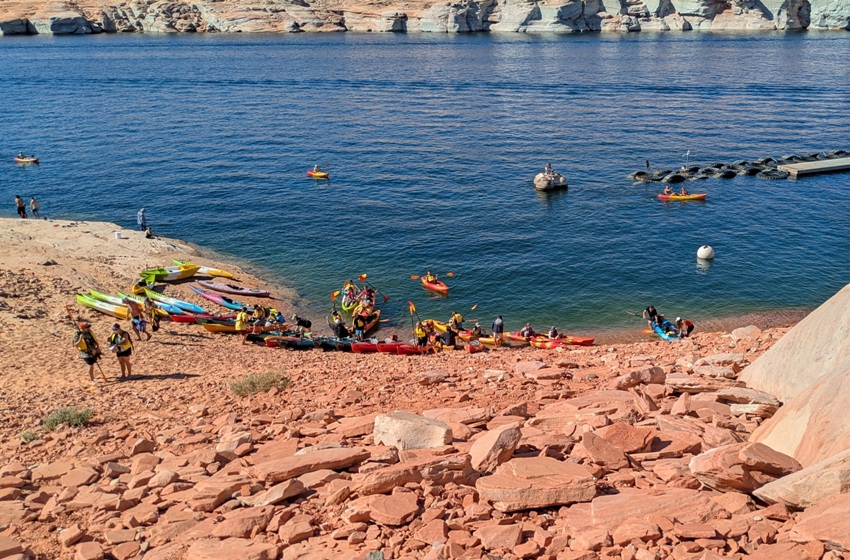 People coming ashore with their boats