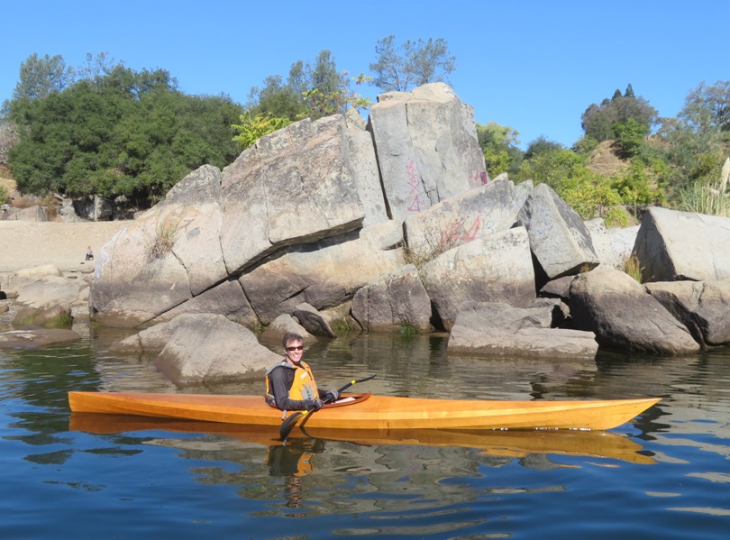 Ken in his kayak in front of white boulders