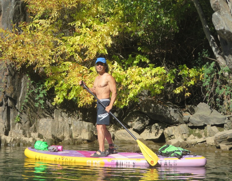 Me on SUP with yellow leaves behind