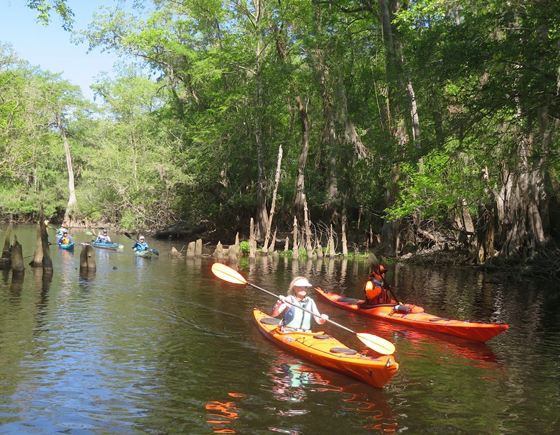 Pam with other kayakers behind