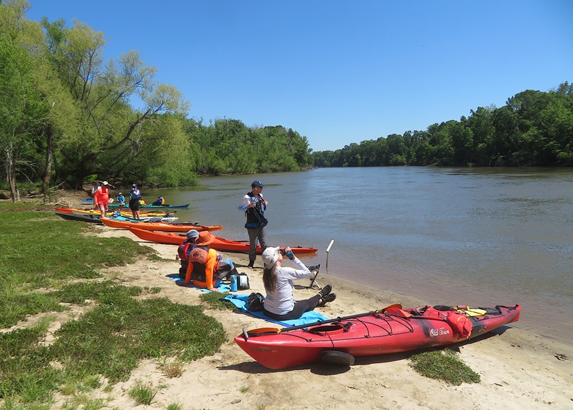 Kayakers on the beach with the Savannah River behind