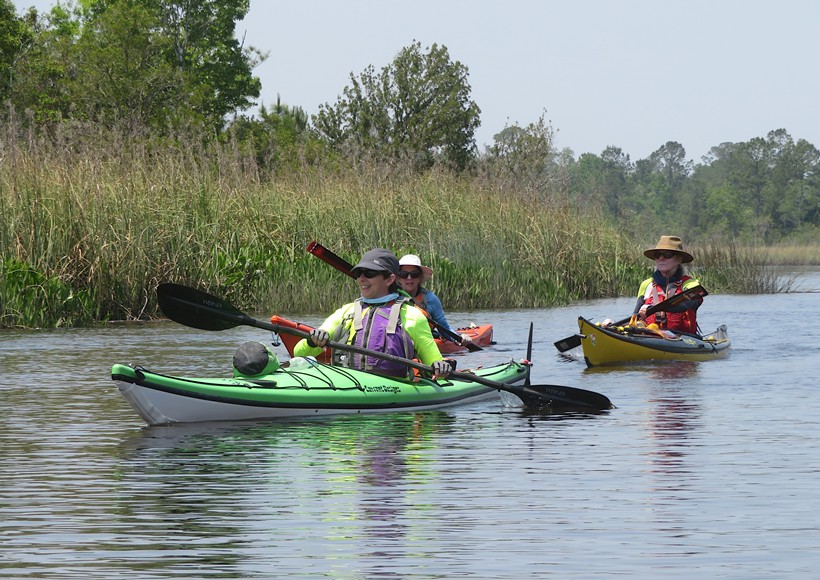 Carolyn with two kayakers behind