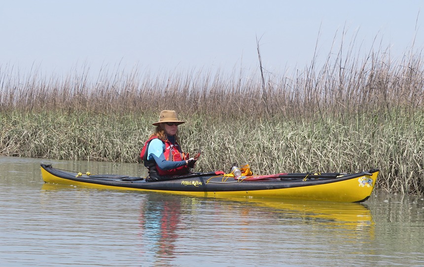 Patty kayaking with bay grasses behind