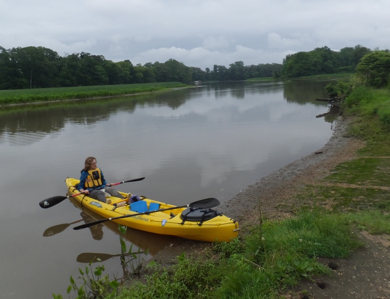 Norma in tandem kayak under dark skies