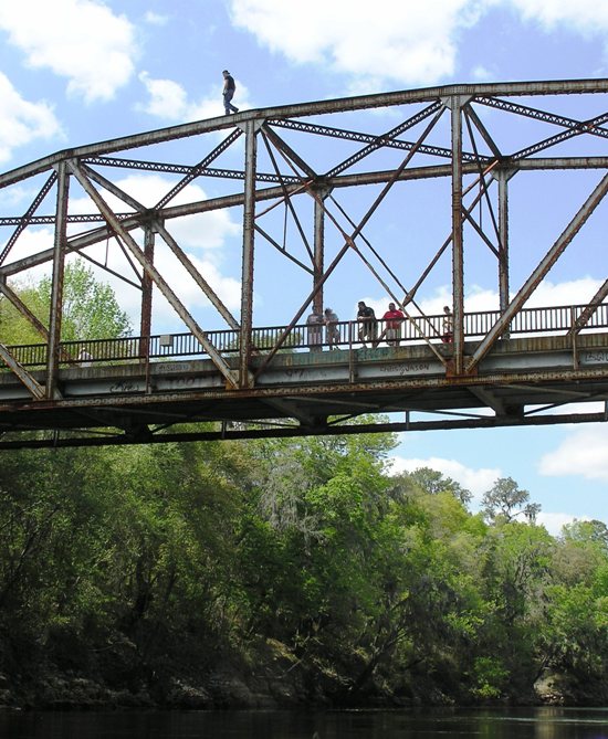 Man walking on top of bridge