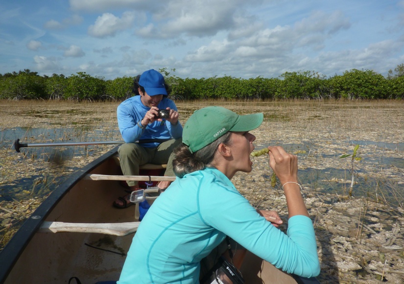 Carmen pretending to eat a periphyton with me behind, holding a camera