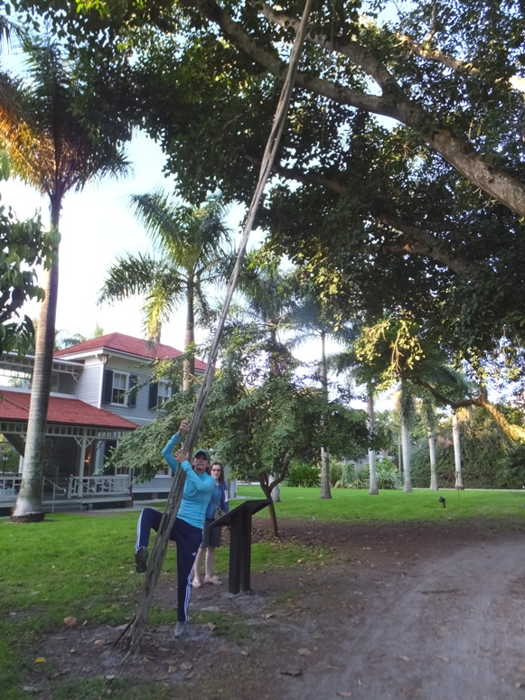 Carmen pretending to climb up a vine but not actually doing so
