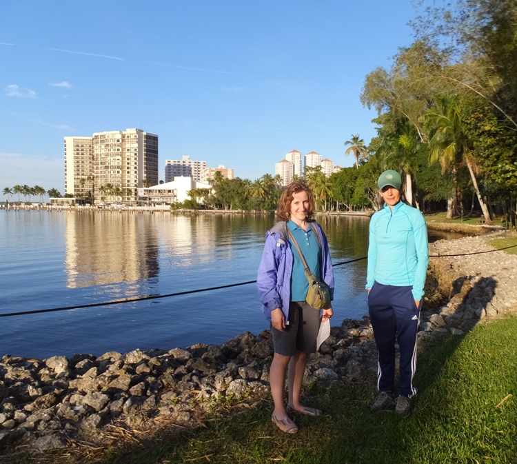 Norma and Carmen by the water with tall buildings in the background