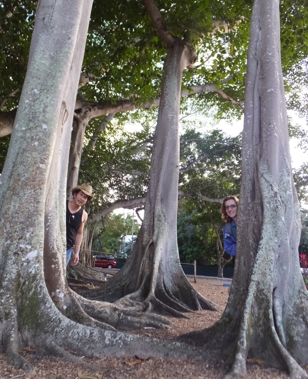 Norma and I peeking out from behind trees