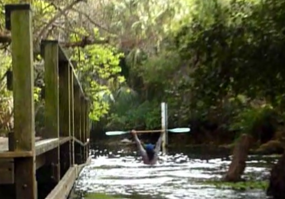 Rear view of me paddling over the dam