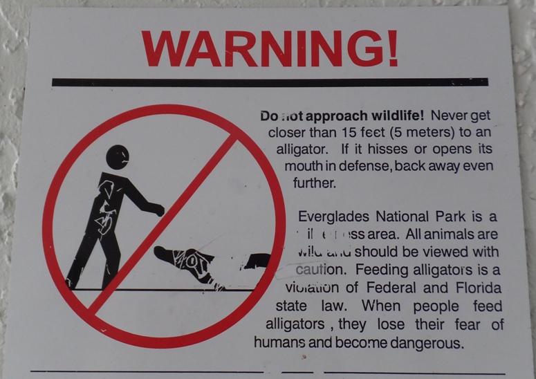 Sign telling people to stay at least 15 feet from alligators