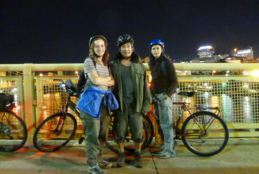 Norma, Carmen, and me on a bridge at night with bicycles