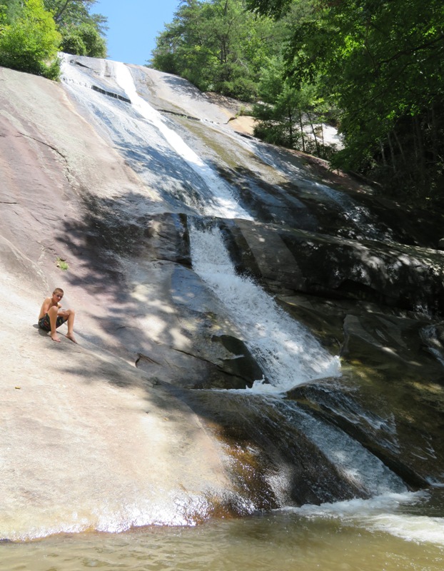 Kid sitting beside Stone Mountain Falls