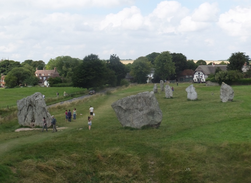 People by stones with town in background